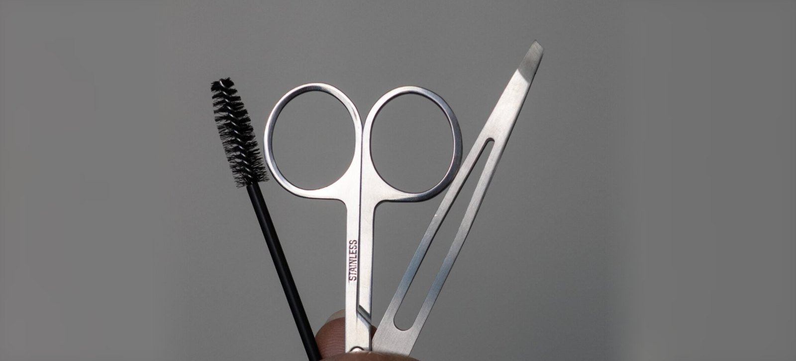 Brow shaping tools: spoolie, brow scissors and tweezers